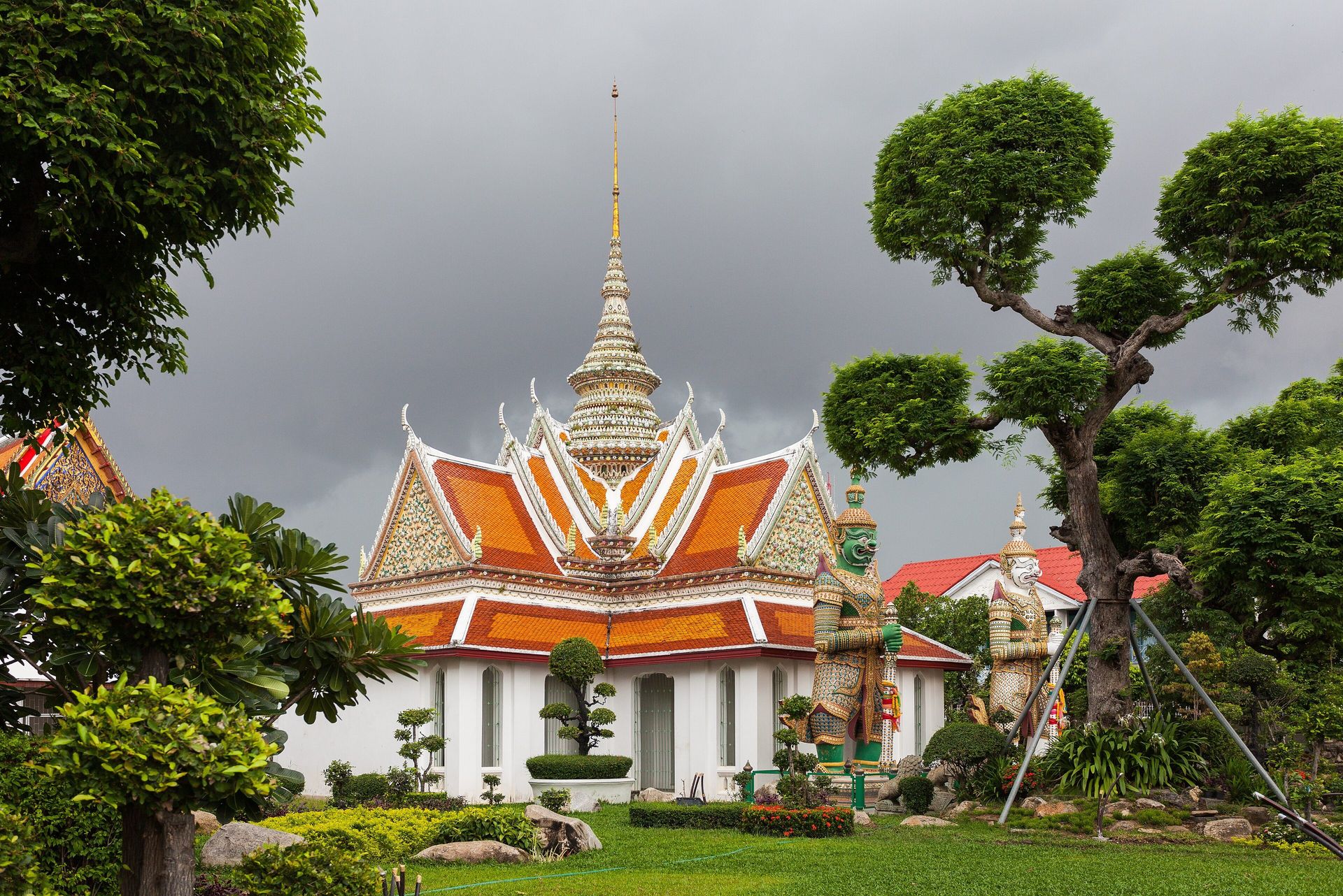 A traveller studies a Thailand map with a notebook and smartphone at a refined desk.