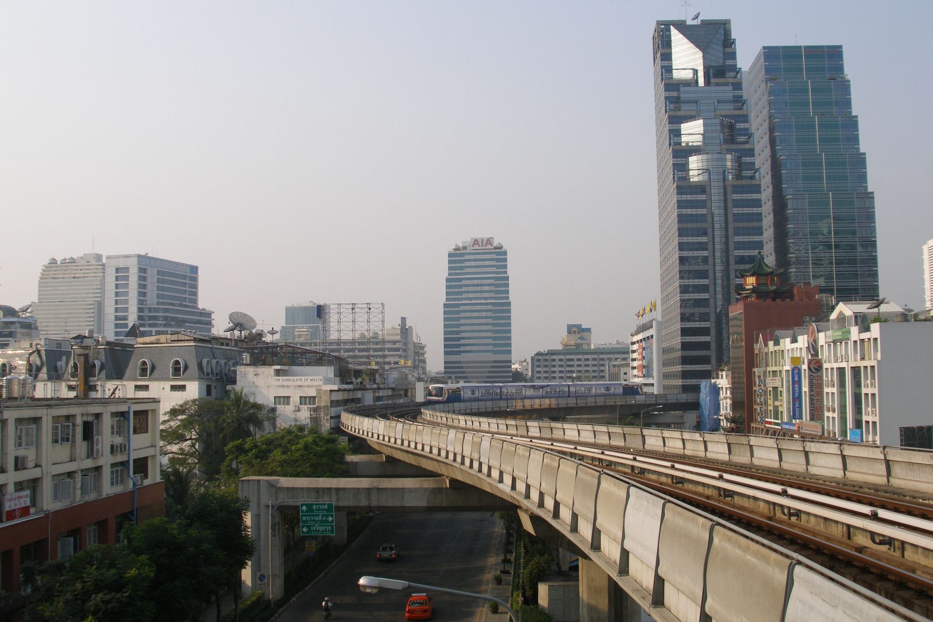 Elegant Bangkok hotel room overlooking the Chao Phraya River and temple rooftops.