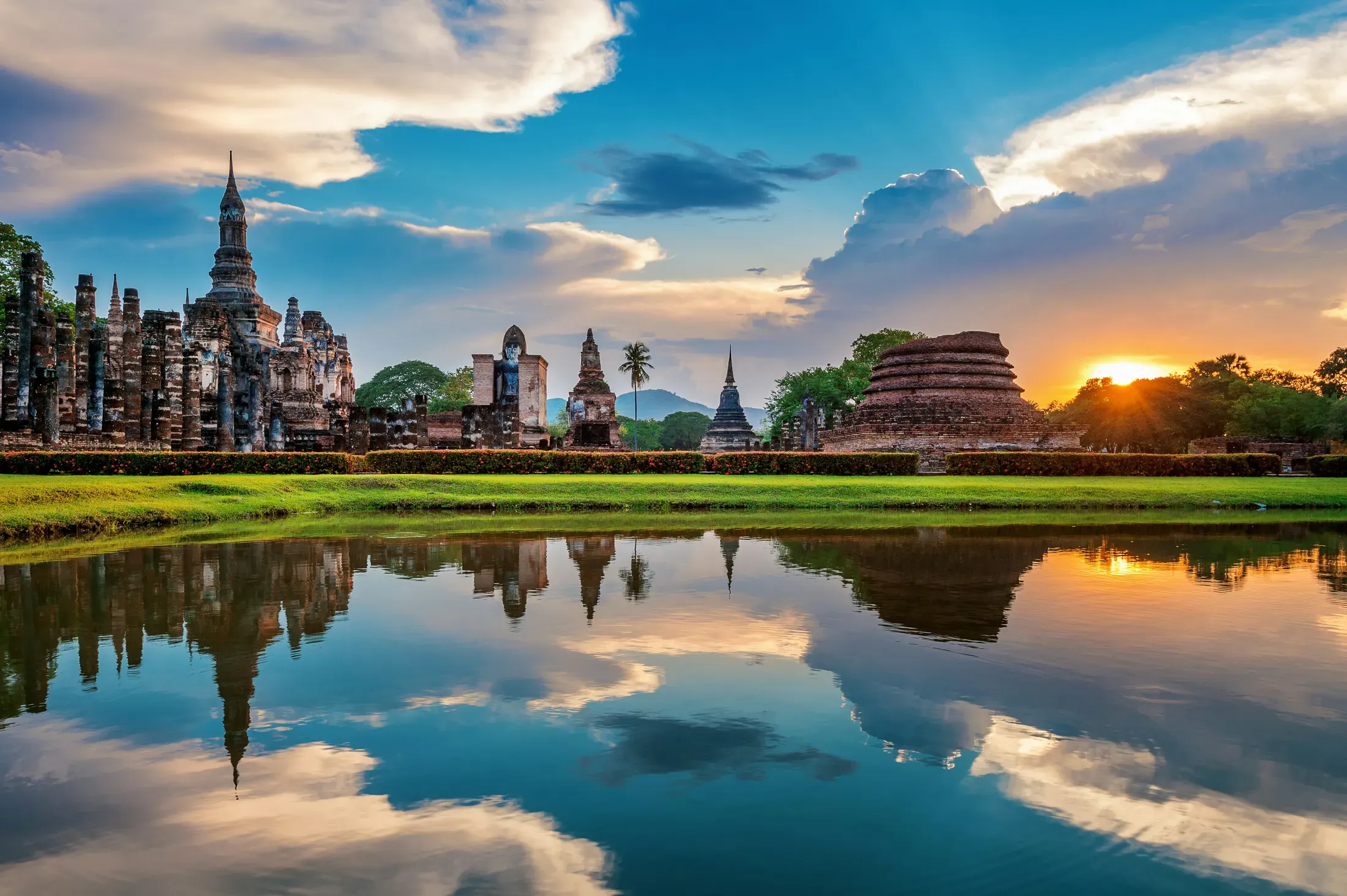 Thailand travel collage with a temple, mountains, river, and quiet beach.