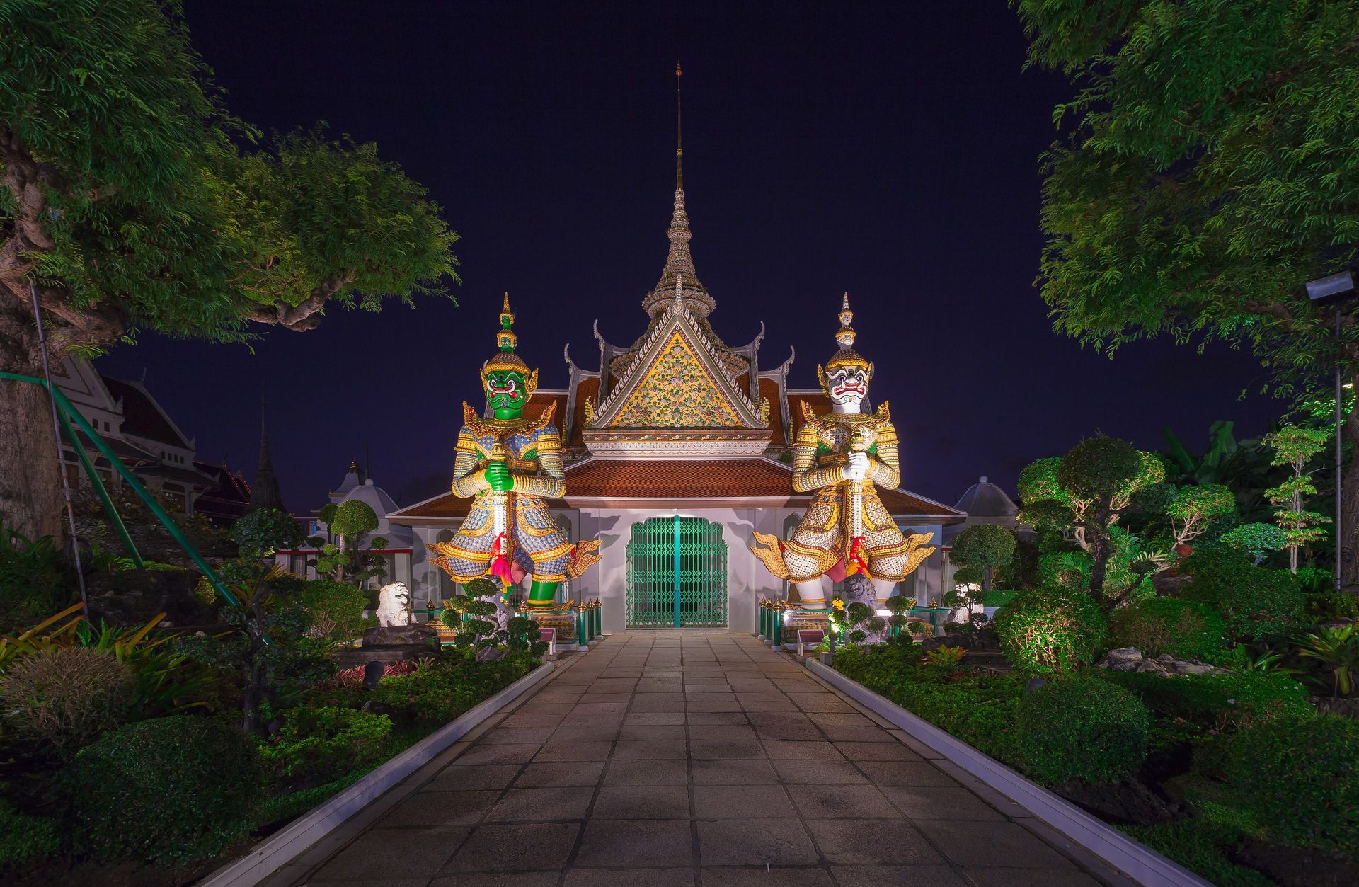 A travel designer reviews a Thailand map with a notebook, passport, and phone.